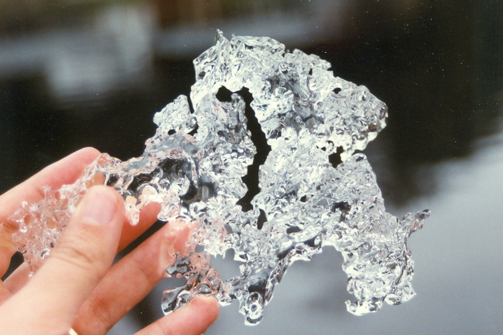 The sheets of cold broke easily at the edges. The broke bits were this thick.