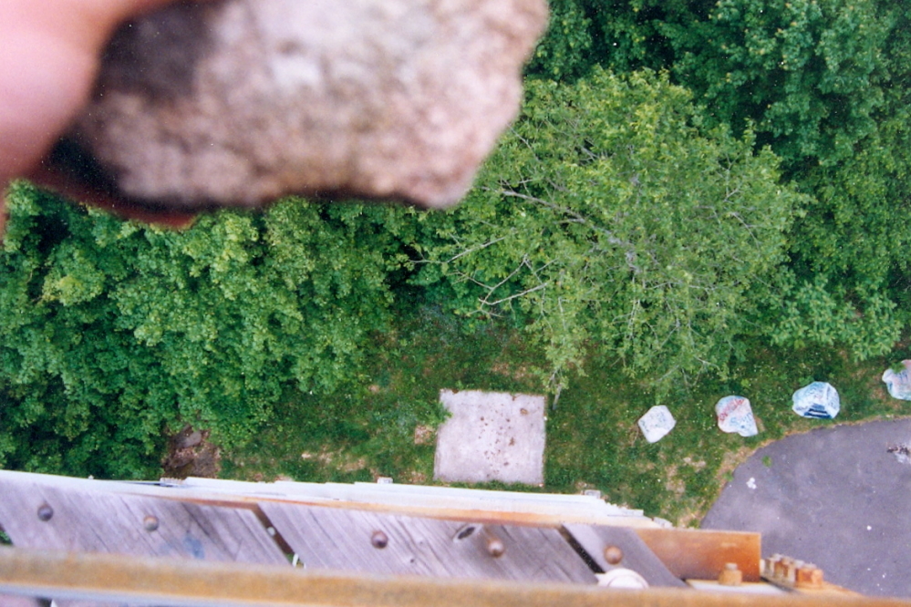 There's a slab of concrete on one side of the tower. Rock dropping is more fun when you hit the slab.