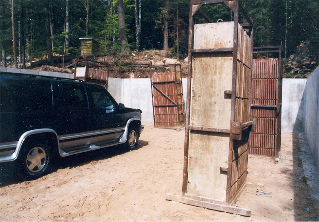 The new car hole has new cement walls. It's populated with cement wall forms and our truck.