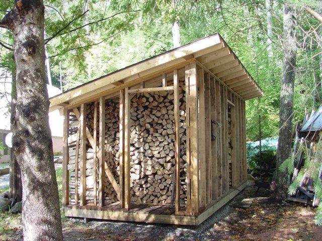 The logs are piled in the woodshed with care with the hope that cooler temperatures soon will be there.  I'm told we still need about a cord more.