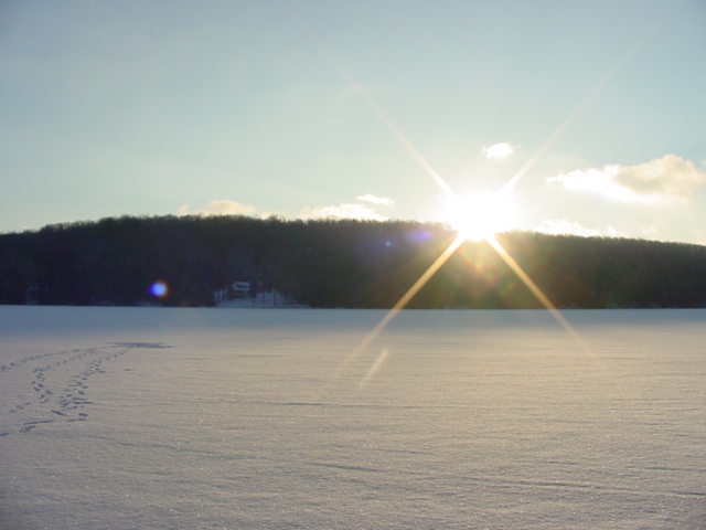 The clouds and precip were gone by Saturday morning.  It was a bit cooler (16°F) and 1 inch of new snow was on the ground.  Marching around on the lake taking pictures made us really hungry...
