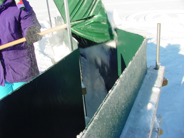 The wall forms were setup and filled with snow.  Three of the forts used a new "Dry Pack" method: snow is piled into the form and the pressure "polymerizes" the crystals in about an hour.  The result is a light, strong wall ready for decoration.