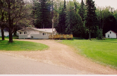 This is the same area from August 2006.  There is no trace of the road to the right but we found part of the foundation of the structure in the middle.  I'll try to post an old and new picture at least once a month.