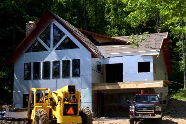 The new houses on the north end of the lake are plodding closer to done.  The west one is getting stone applied to the sides and a deck bud has sprouted in the front.