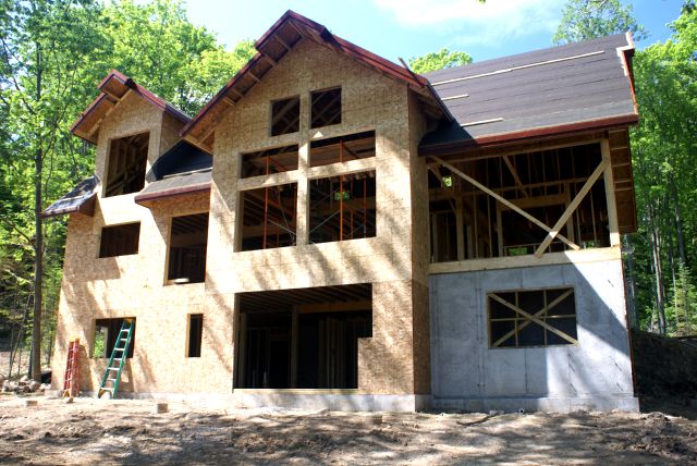 The eastern one is looking, for lack of a better word, huge.  No windows yet but the roof is papered.