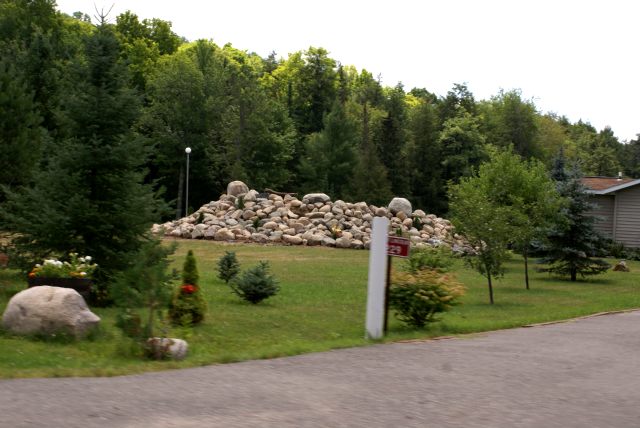 The boulders that had been put into the inflow creek in the northeastern corner of the lake have been removed from the stream and made into a rock hill.