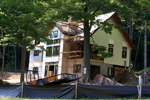 The construction on the eastern house featured rock being added to the chimney.