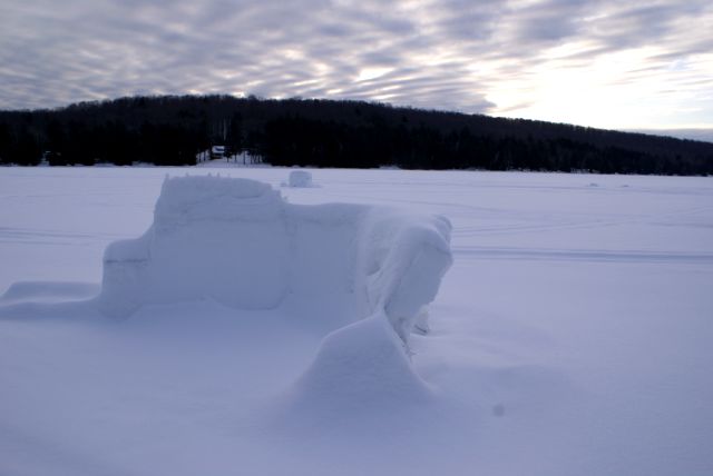 The brief warm spell, just after the bottle rocket war, was not kind to the forts.  The walls were thinner and tippy-er.  One of the forts was destroyed by a pack of snowmobilers enraged by its lack of aesthetics.  I'm not completely sure  what the snow critics said about "Baltic Avenue", but I heard it went something like, "Me no like this fort, me break it now!"