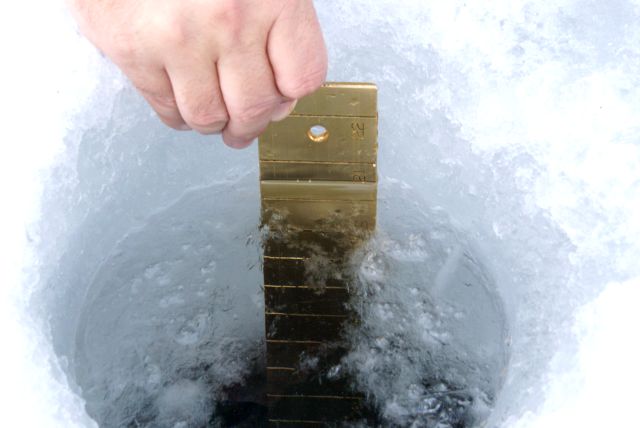 After pushing through several inches of snow to get to it, the ice was found to be almost 22 inches thick.  It should peek in a week or two.