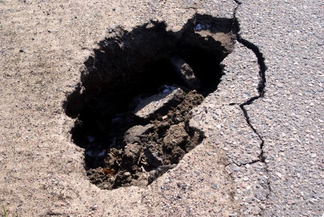 It's only 1 by 2 feet but it's deep, about a foot and a half deep.  Deep enough to damage a front passenger side tire and suspension.  Be careful.