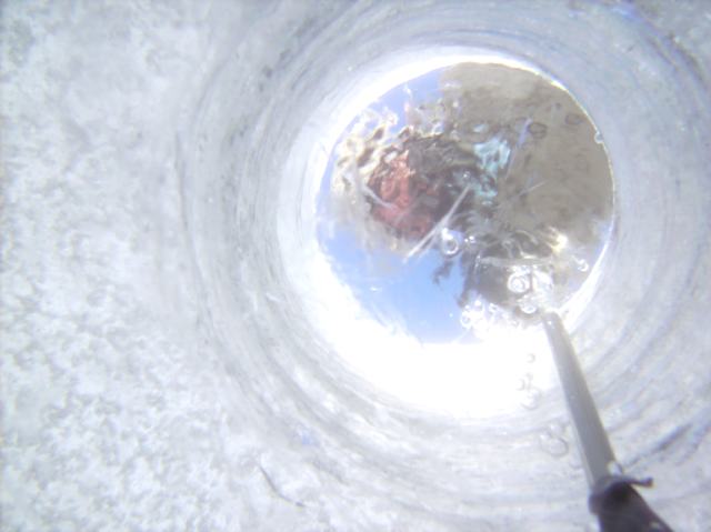 Last week underwater pictures from the bottom of the ice hole had less ice, snow and clouds blocking the sun light.  The picture was "happy" (but trapped in a camera for want of a strange USB cable)..