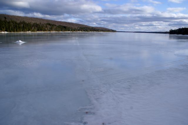 The 5 Phases of Ice-Out<br><br>Phase I :  The snow begins to melt and patches of ice become visible.<br><br>Phase II : Liquid water begins to pool on the surface of the lake.  It is not uncommon to have a strong cold front push the state of the ice back to Phase I (Boo).<br><br>Phase III: Ice begins to pull away from the shore.<br><br>Phase IV:  The ice turns black (rotten ice) and puddles disappear as the water seeps into the increasingly porous surface.<br><br>Phase V: The remaining ice begins to move, piling up on which ever shore is downwind.<br><br>Phase II of ice-out 2011 slipped back to phase I on Sunday.  Boo.  It's going to take some really freaky hot weather to de-ice the lake and open the golf courses anytime soon.  There is still close to 2 feet of snow in the woods.  That should help with the lake level when it melts.<br><br><br>-Nemo dropped his funnel and ran at the first sign of revolt.