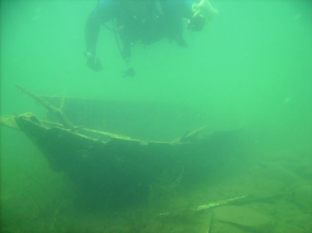 The old boat hasn't changed since we visited it last weekend.  My dive partner wore a full wetsuit.  I had just a swim suit and t-shirt under my BC.  The thermocline is at about 20 feet.  I can personally attest that spending any amount of time below it with only a swim suit and t-shirt under your BC is cold.