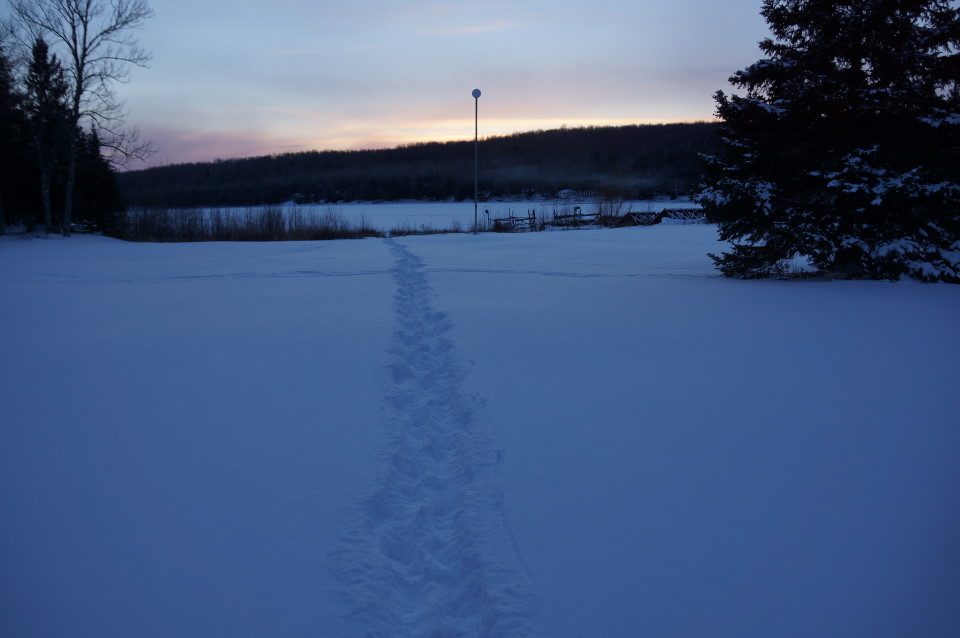 Sunsets have been good with a hint of smoke hovering 3 meters above the lake from wood burners .