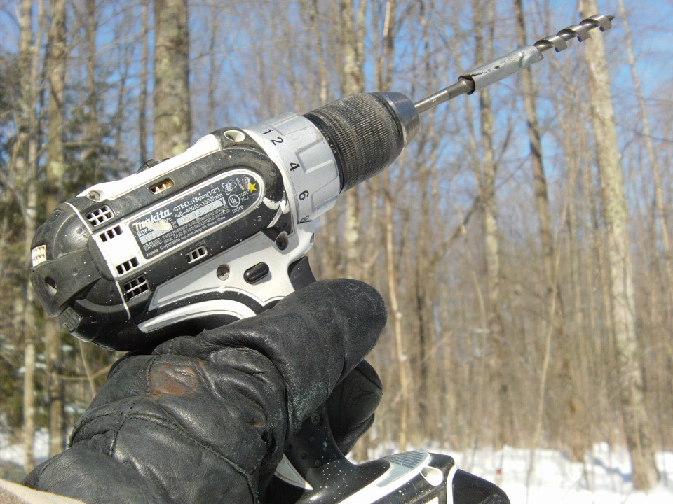 Electric drills (18V) were called into service while the gas drill had its pull cord reattached.  You can get about 20 trees from a full battery.