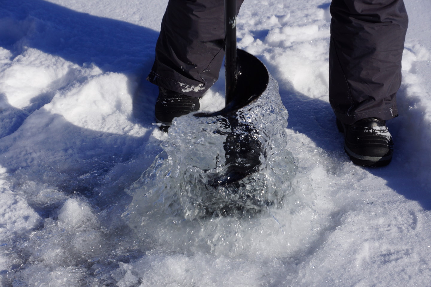 The lake is still covered with ice.  A hole was drilled to check its thickness.
