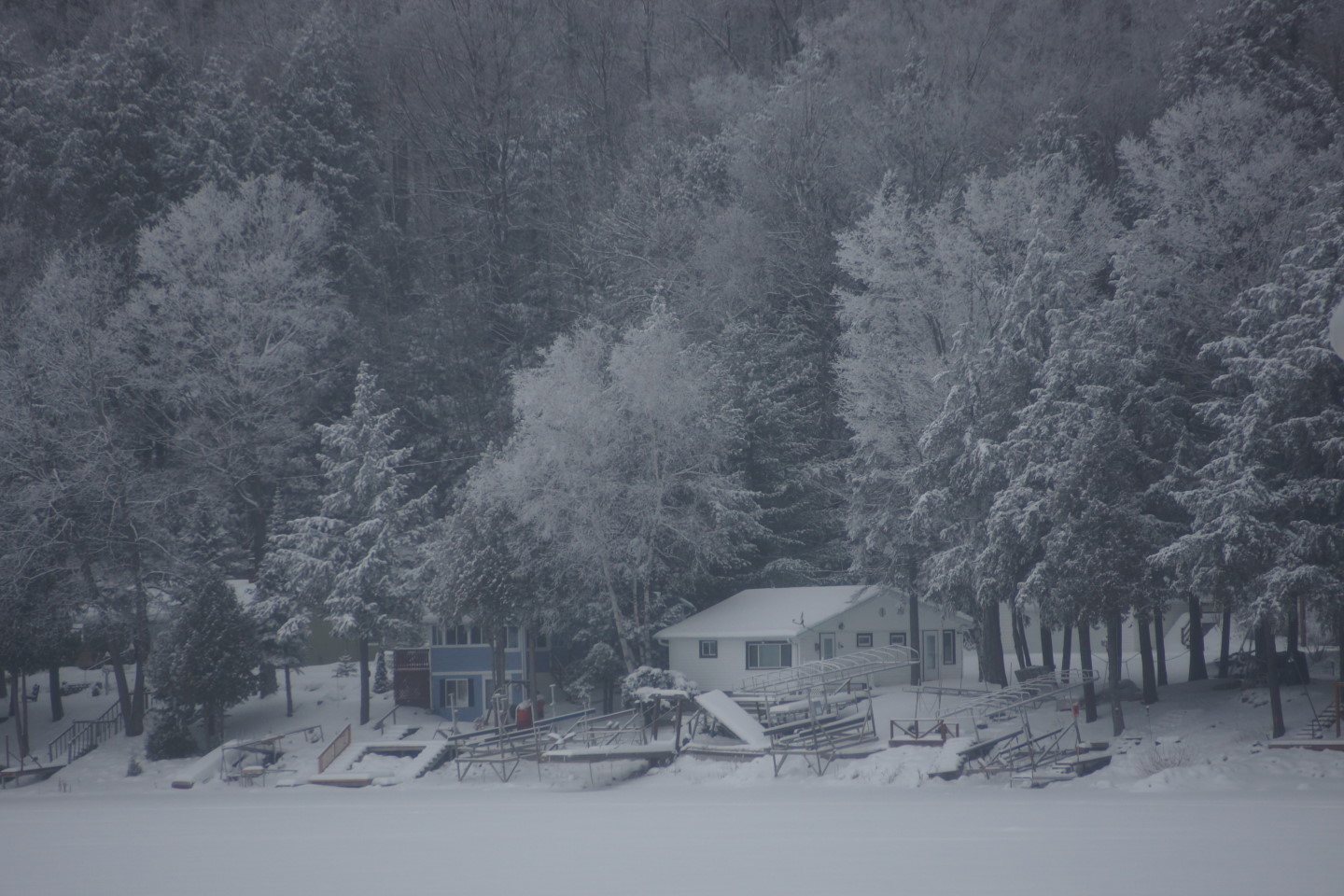 The temperatures were almost 50°F warmer by the weekend and it snowed.  The lake got about 3 inches of very dry powder.  The many small snowfalls are really adding up.  There's about 9 inches on the lake and you can't fling a pan of boiling water without hitting a snowmobile.