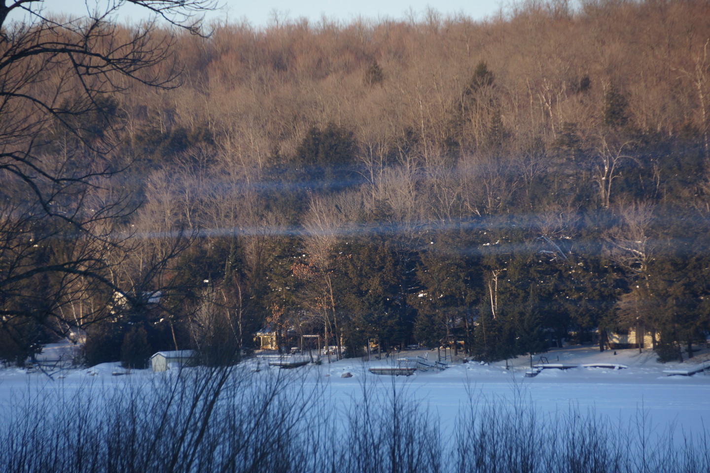 All this year, on still mornings, bands of wood smoke dance above the lake as those on shore struggle to keep their cabins warm.  This week was no exception.