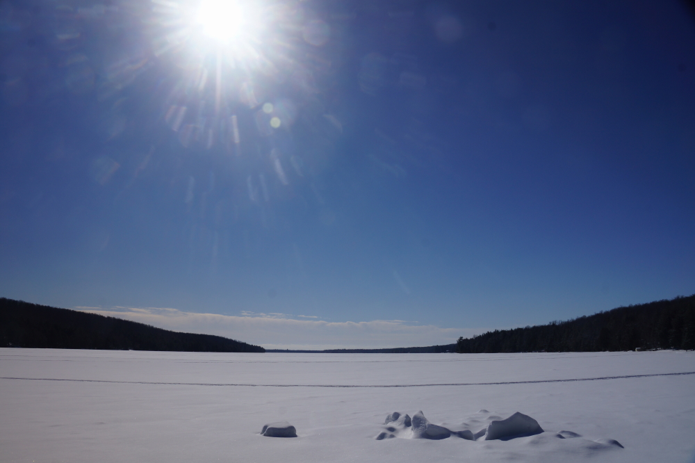 The above freezing days and below freezing nights shrunk the lake snow and grew the lake ice.