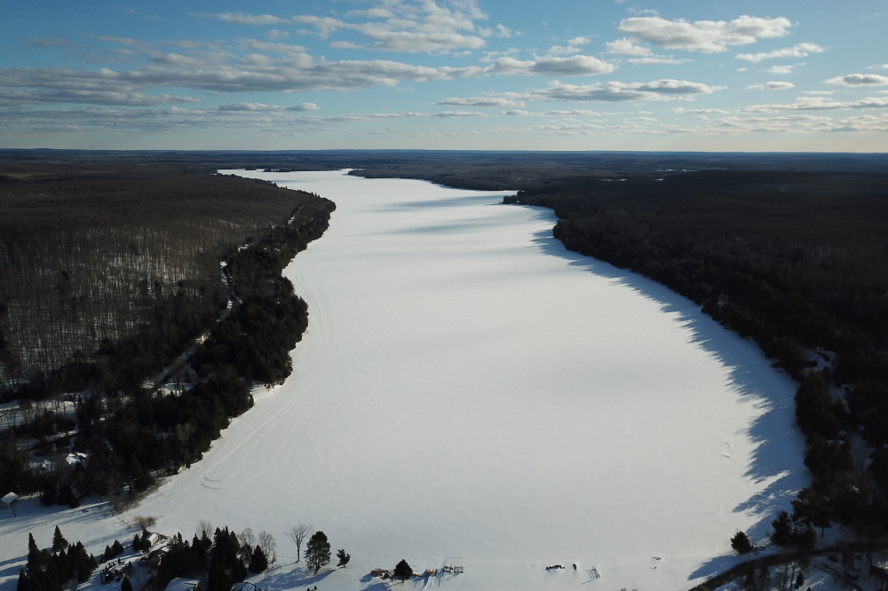 The snowmobiles got a bonus week and ice-out contestants got a more complex problem. You'd think that an extended cold would push ice-out back, but it can also result in a more violent early Spring.  Savage Spring takes the ice faster. Still, we think that the lake will be ice free by June. Not so sure about the snow in the woods. Having sunk up to the belt while wearing snowshoes does not bode well for a snow free July.<br><br>-Nemo dressed in layers, still got cold.