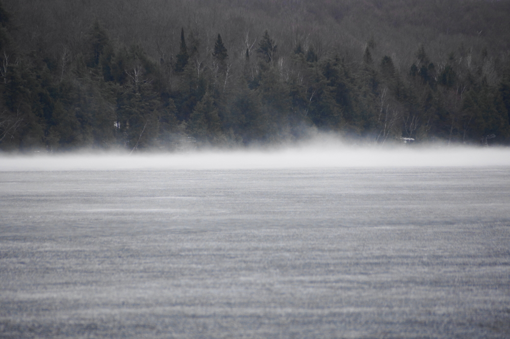 Great banks of fog moved down the lake until they condensed on the icy surface.