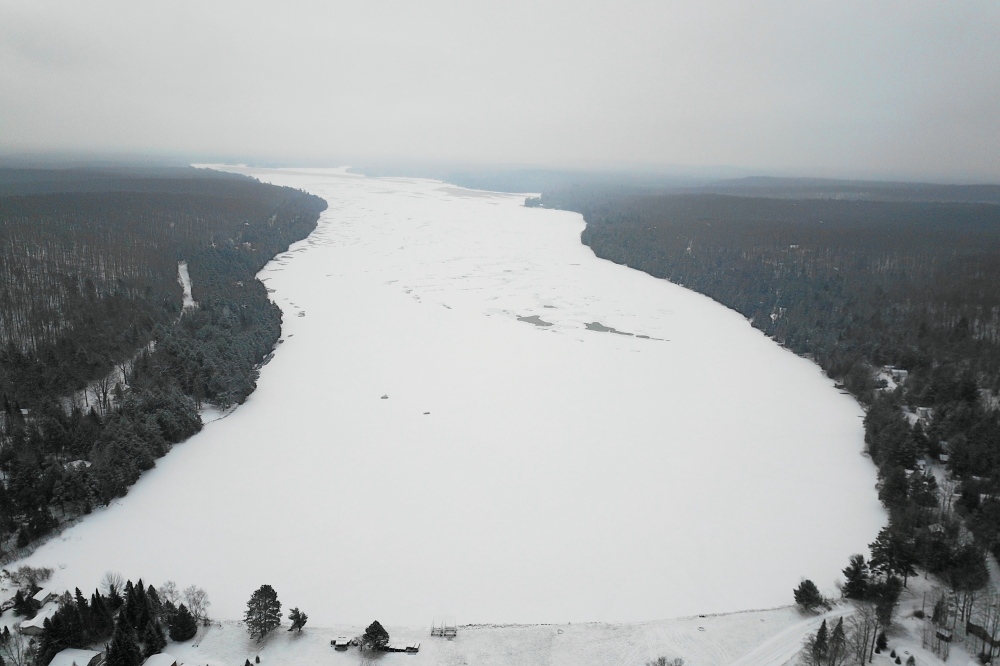 Two days after the de-piering, a few small patches were all that remained of the open water. Later in the day, many of the patches froze over and The College of Loons was ready to call it.  A last check of the lake in front of Water's Edge surprised the lake's not so secret secret society. There was a long strip of open water filled with waves and ducks.  The official call of ice-in was delayed.