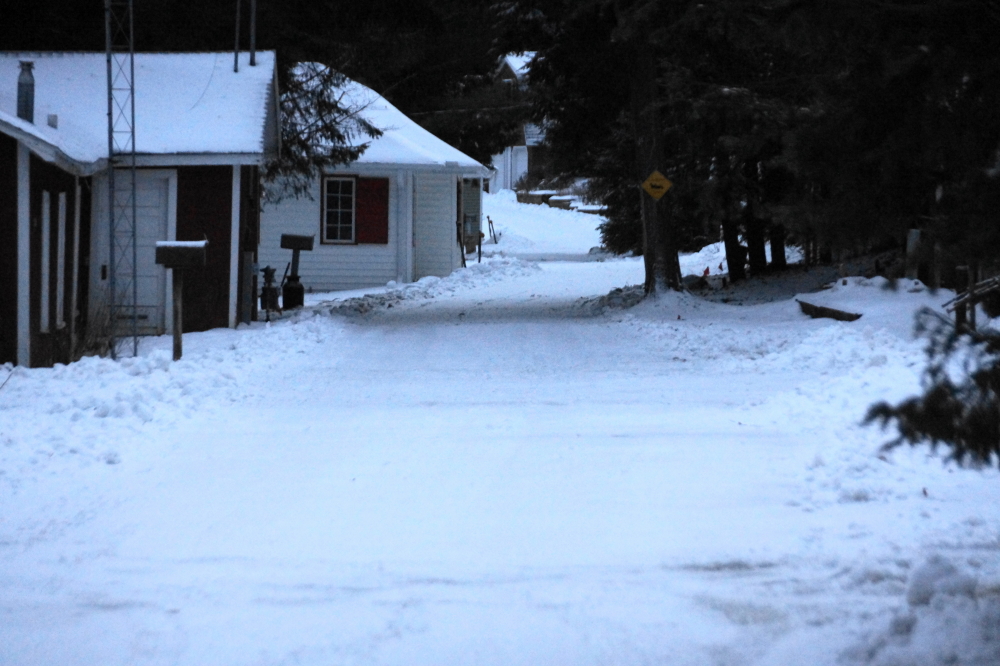 The "Wintery Mix" followed by more seasonable temperatures (burr freezing cold) has left Knott Lane with about an inch of hard, clear ice under a dusting of Winter.