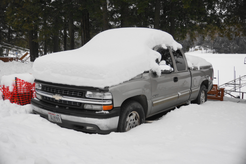 Sleeping vehicles have a nice coat of white but due to a few melting events, they are still exposed enough to distinguish them from random lumps in the snow..