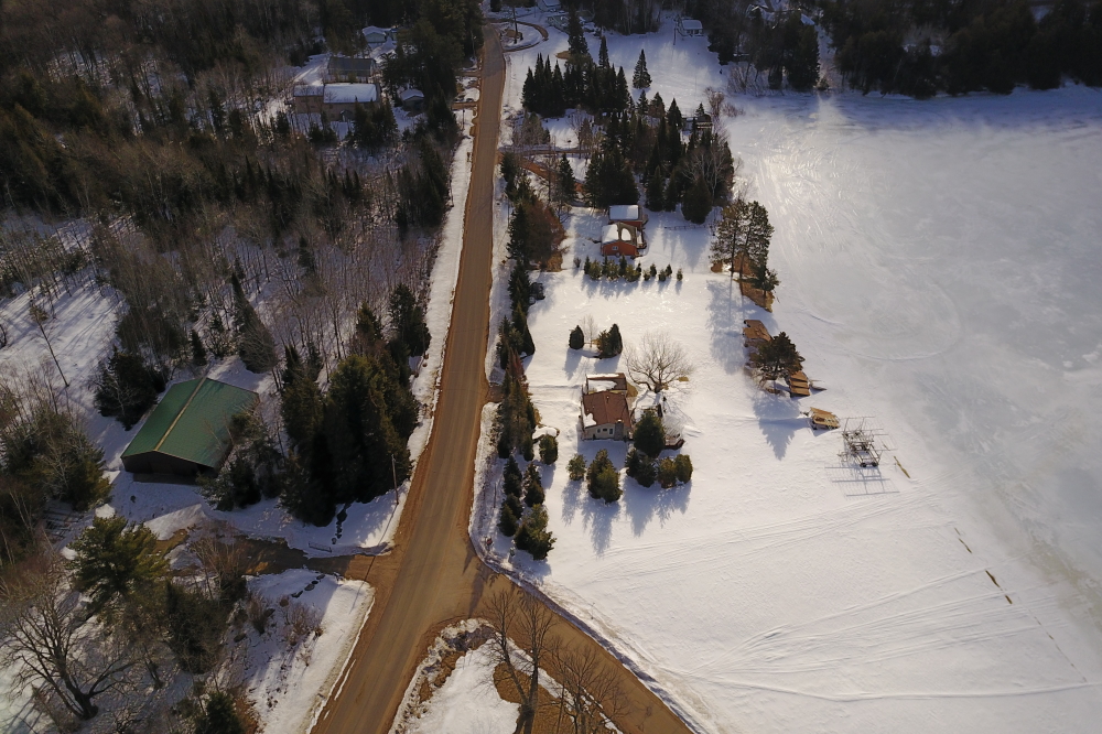 The warm air and then the cold clear has absolved roads around the lake of their ice, leaving only a sand dusting.