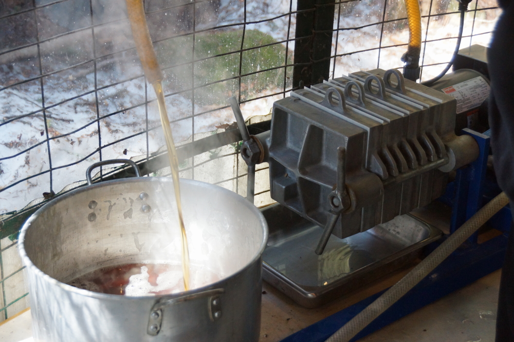 Eventually the boiled down sap became syrup and was rushed through a plate filter and into bottles.