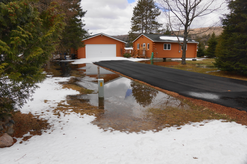 When it finally warmed up, the melt produced some impressive lawn puddles. If you're stepping outside the cabin, don't forget your PFD.