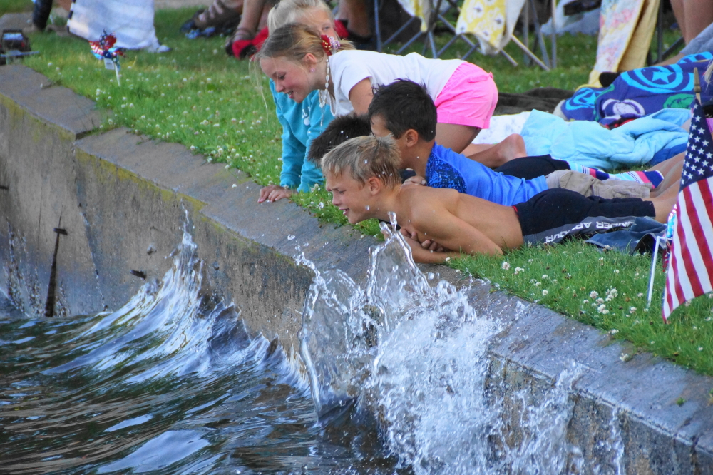Most of the crowd stays back, but there's a few bold men and women that embrace a closer, wetter view of the show..