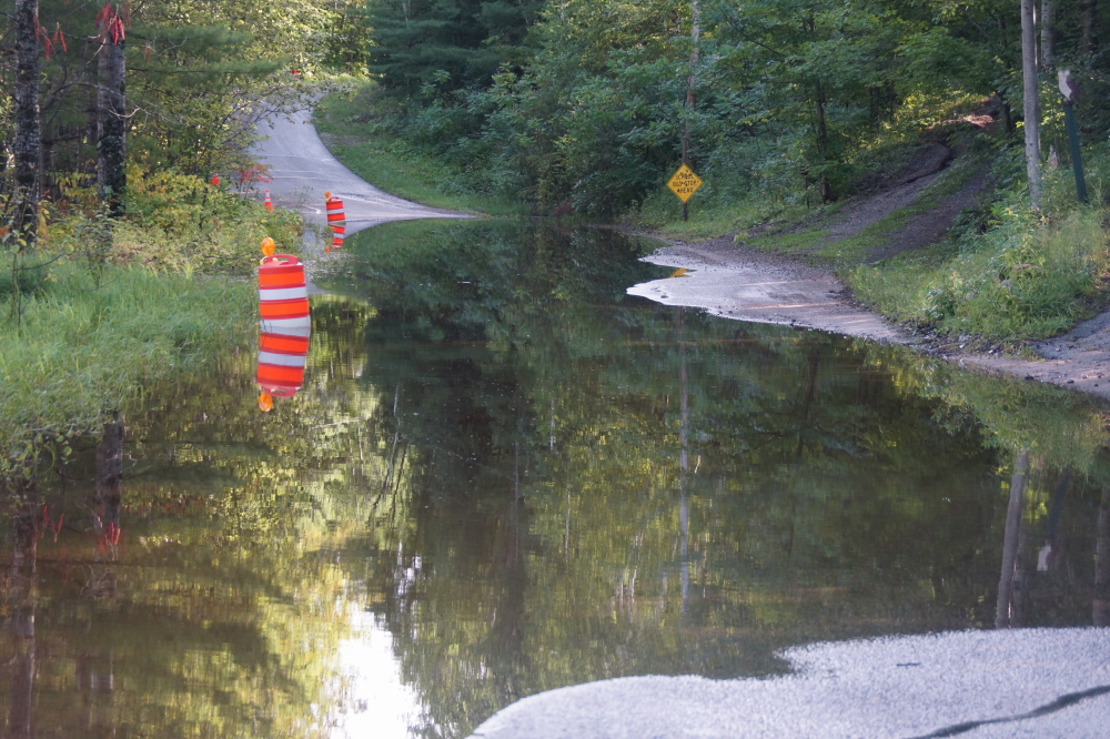 There's talk of a gravel dump to bring the road up some. Until then, turn on your cars running lights at sunset and slow no wake.