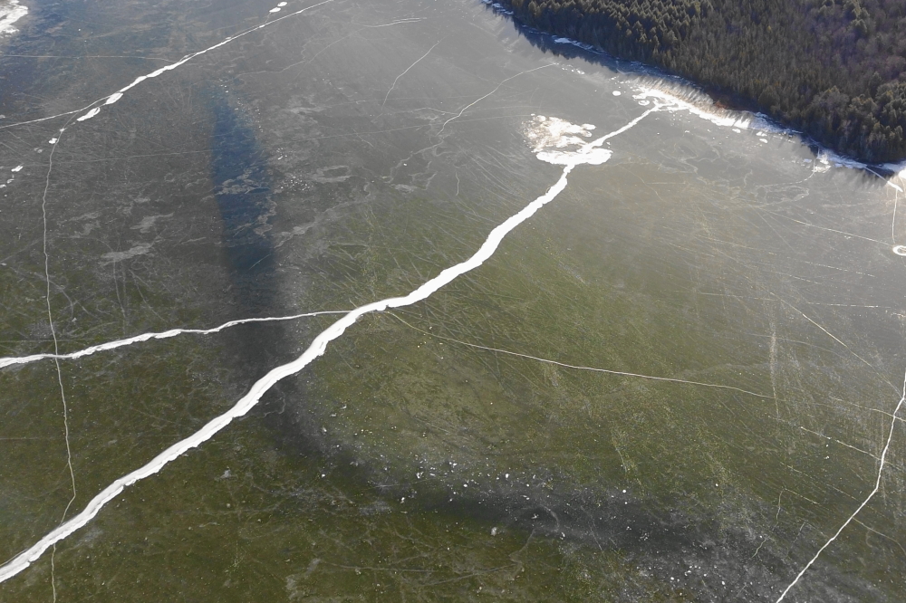 While flying over Wabikon, we imaged a huge, black mass under the ice that led to much speculation. Biggest musky ever? Crack in the earth leading to caverns filled with <a href='https://landofthelost.fandom.com/wiki/Sleestak' class ='defaultlink2' target='_blank'>Sleestak</a>? A very lonely <a href='https://en.wikipedia.org/wiki/Plesiosaurus' class ='defaultlink2' target='_blank'>Plesiosaur</a>? It's no wonder Wabikon lacks swimmers or as we call them "bait".