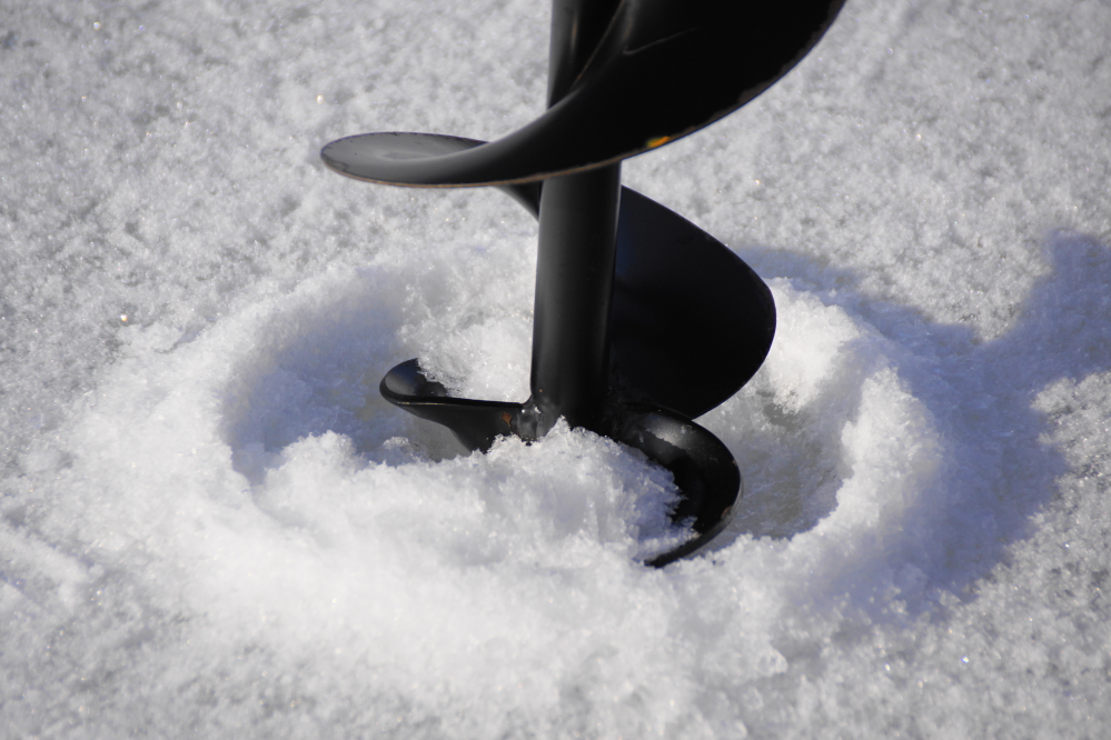 Drilling a hole goes much more quickly than later in the year when the ice is a few feet thick.