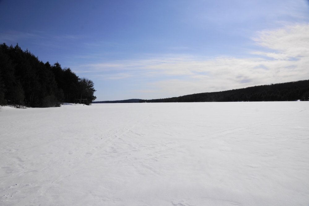 The lake ice's width is going in the wrong direction. For those that would prefer an early ice-out, the good news is the nature of the surface ice. The top 2 inches is thick, but under that there's a 2 inch water-slush layer. Under that is hard, clear stone. A week or so of a normal late March should take care of the top layer. A warm start of April could have a few crazy people swimming just after Easter. With all the snow currently on the ground, we don't see the NCC golf course usable for even the most devoted duffer for the rest of March. With all the wind, there's not much snow on the lake. Lake golf season should start next week just as soon as a few holes are plowed. <br><br><br>-Nemo's about 180 yards out, looks like he's gonna use a 9 iron.
