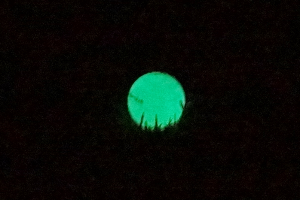 You charge the balls by exposing them to a special blue/UV light. The glow lasts for about 7 minutes. They hit surprisingly well. The second best part was the green parabolic arc traced in the air after a shot.