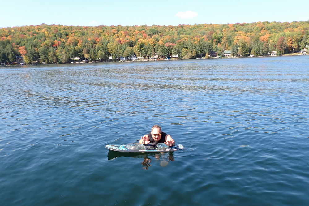 With the calm and relatively warm lake, skiing was a must for anyone with a boat still in. Personally, I like a wee bit of chop when skiing. When the lake is glassy, I prefer skipping over its surface on feet, trick skis, or a kneeboard. Since I don't actually foot or own a pair of trick skis, the flat was kneeboarded up.