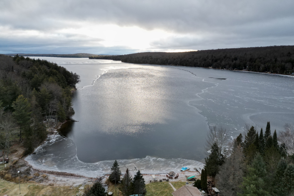 The sun set on a mostly iceless lake on Saturday. On Sunday, thanks to a cold, still night, about 75% of the lake was ice covered.