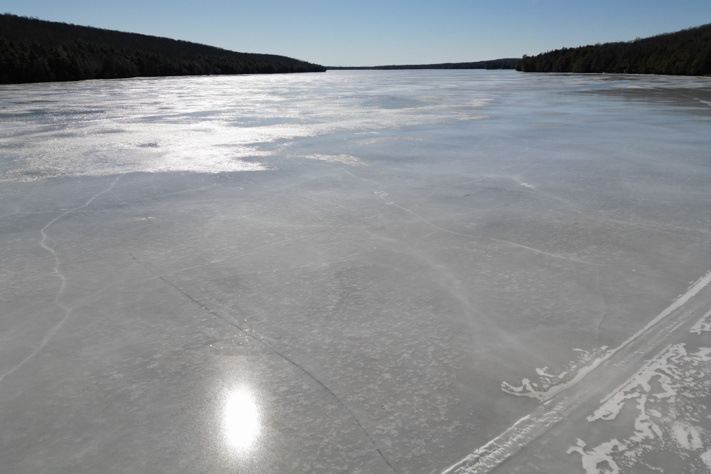 The thaw/freeze cycles have given the lake the kind of finish that delights ice skaters and extreme curling fans. I'd guess that pushing a stone from the north end of the lake to the channel between the islands would be like a hole in one on a par four.