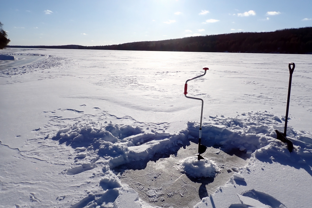 On Sunday, after over 24 hours and counting of negative (°F) temperatures, we were curious about how much additional ice was on the lake since the last check. There were hats, gloves, and boots involved.