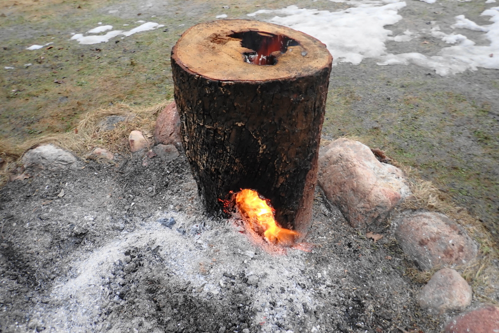 A fire stacked on one side of the log carved a hole through the unrotten outside into the dubious middle wood.