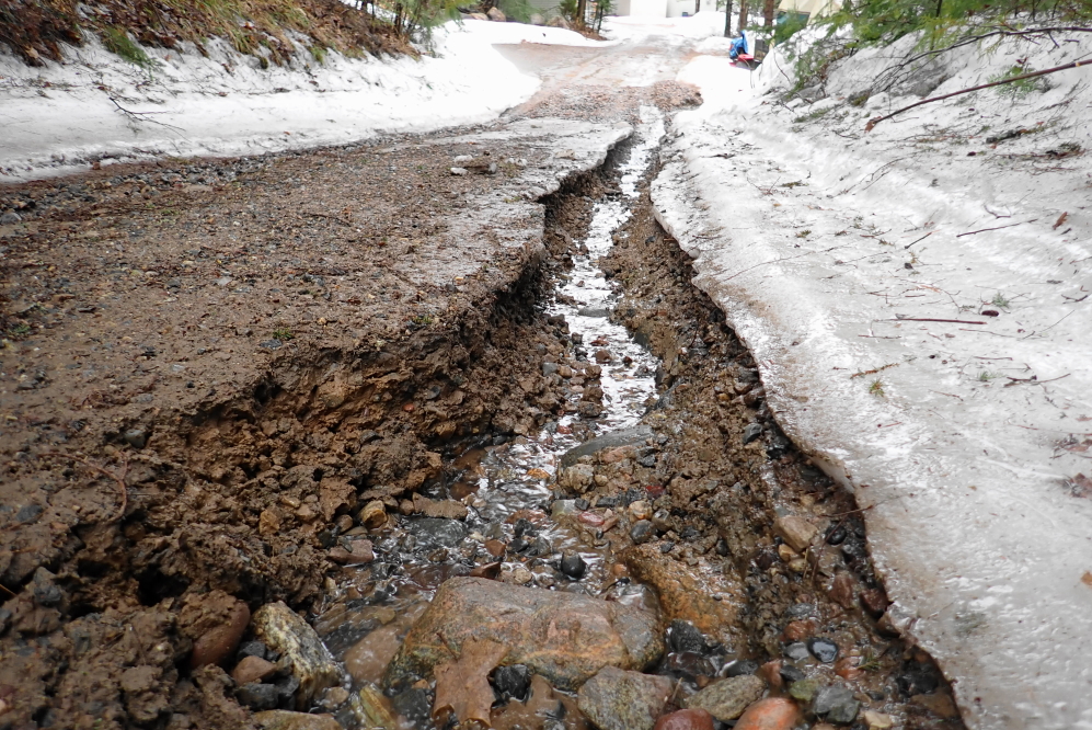 The south end of Knott Lane has a more parallel chasm issue. If a smaller vehicle avoids the lakeside of the road it might make it to the flatter, less eroded parts beyond.
