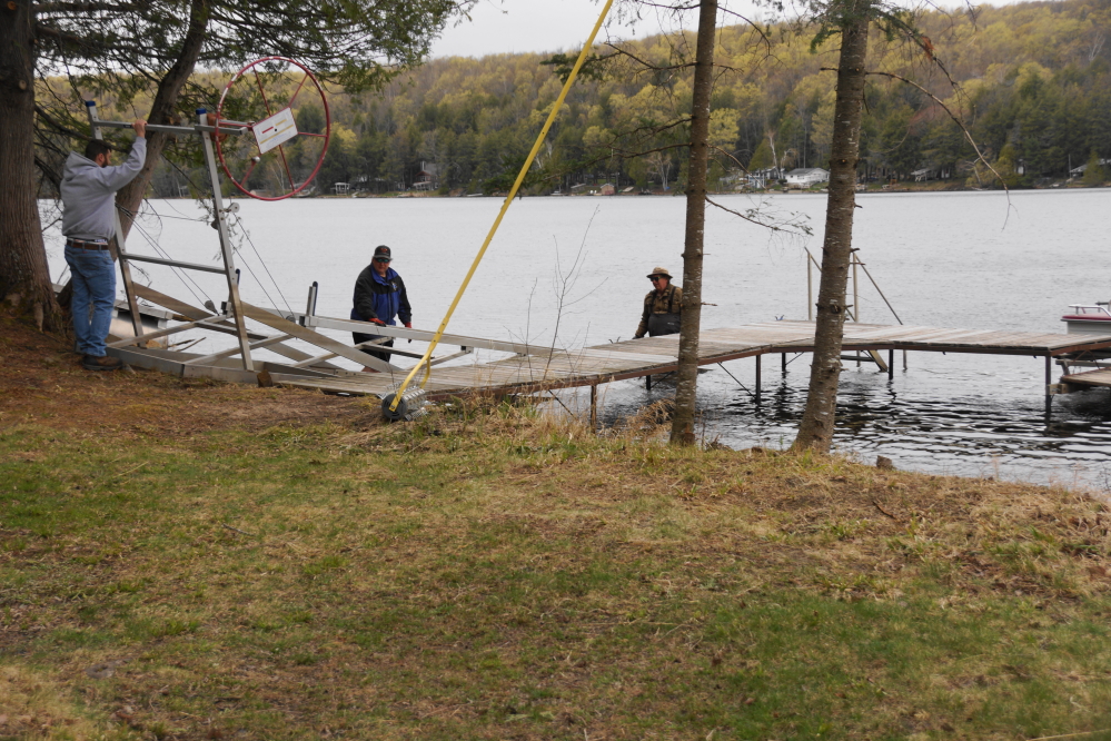 With the pontoon crane guy tooling around other lakes, the men decided to use the old timey way to put in a lift. What using only waders, muscle, and bone lacks in aerobicness more than makes up for with anaerobic induced ibuprofen usage. If the waders are leaky, there's also a hypothermic element.